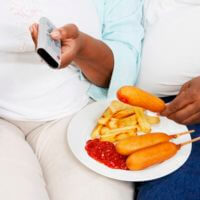 Overweight couple with food. Faces not showing.