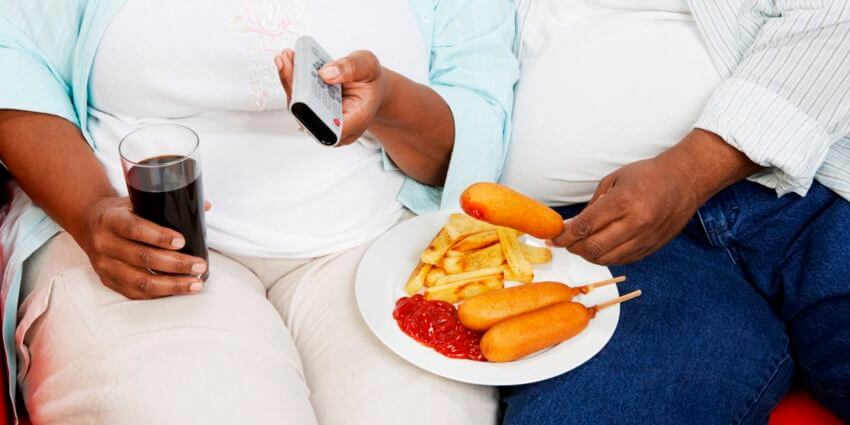 Overweight couple with food. Faces not showing.